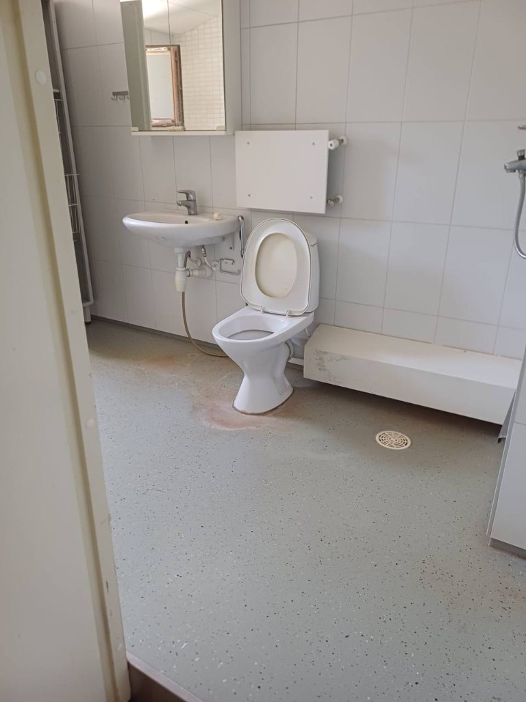 Bathroom floor and fixtures before cleaning