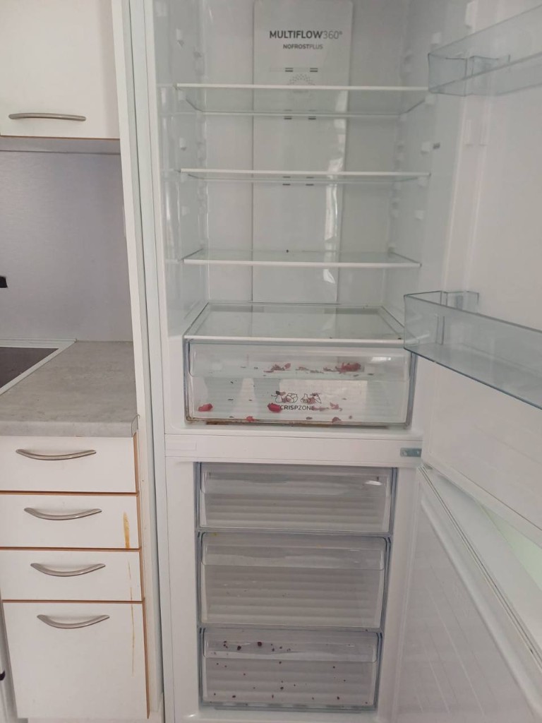 Fridge drawers with food debris before cleaning
