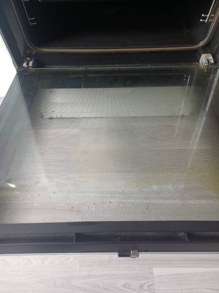Greasy oven door glass before cleaning